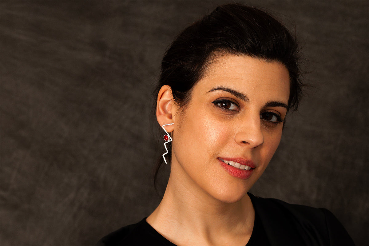 Woman wearing Adonis earrings by Rouaida.