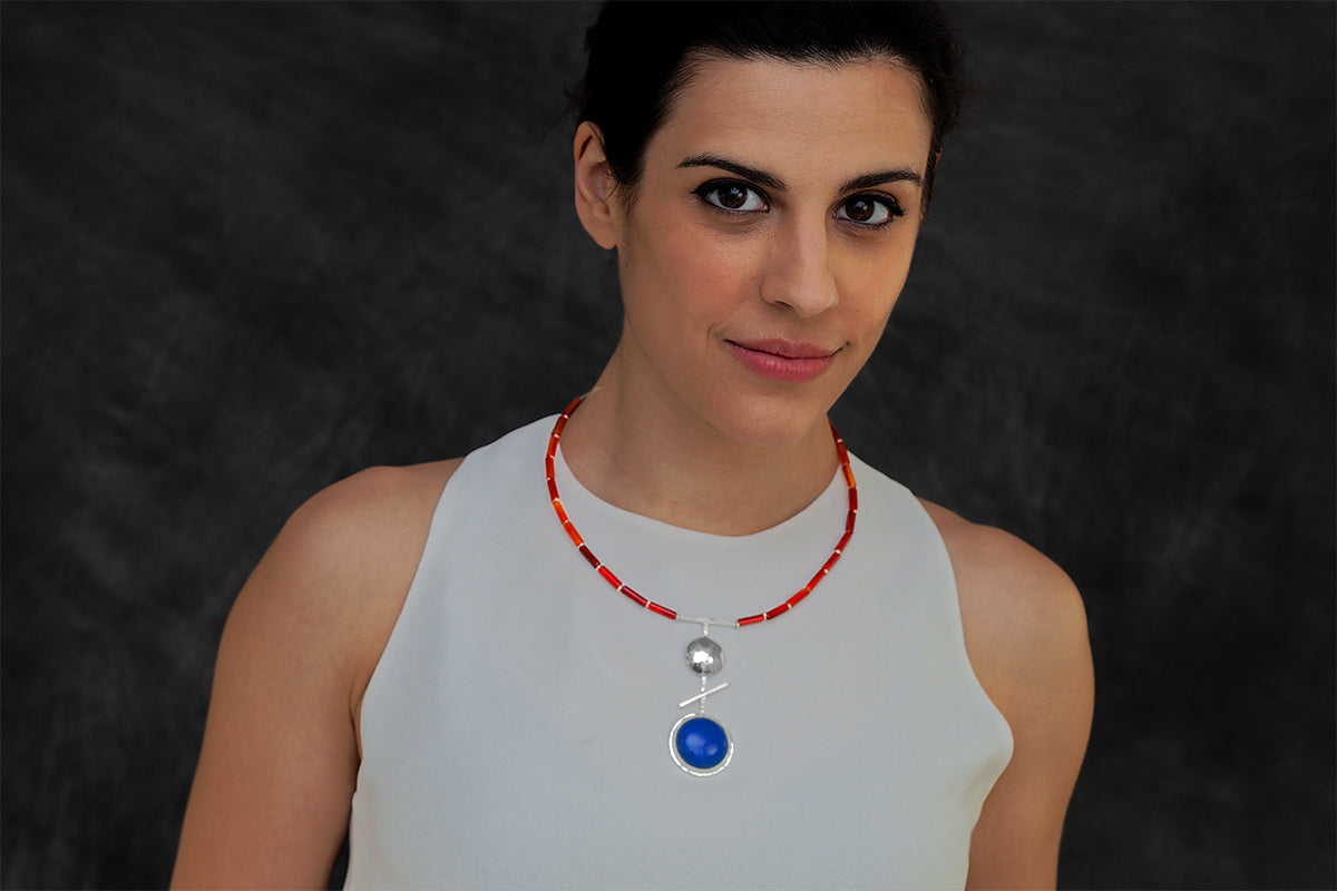 Woman wearing an Orb necklace by Rouaida.