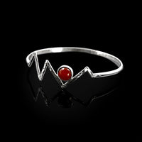 Silver Adonis bangle by Rouaida with carnelian stone.