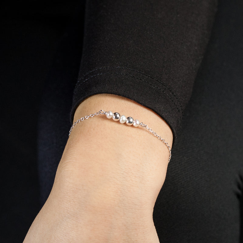 Sterling silver Celestial bracelet with freshwater pearls by Rouaida on model's wrist.