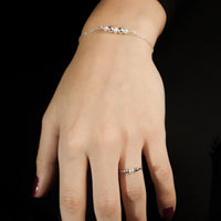 Sterling silver Celestial ring and bracelet by Rouaida on model's wrist.