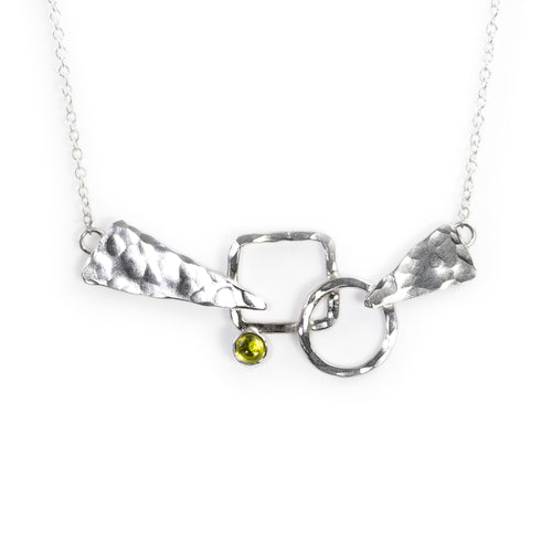 Silver Discordant necklace by Rouaida with peridot stone.