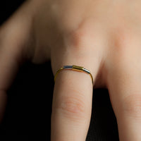 Concentric ring in sterling silver and 18ct gold on model's hand.