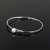 Grace bangle by Rouaida with gold and pearl accents.