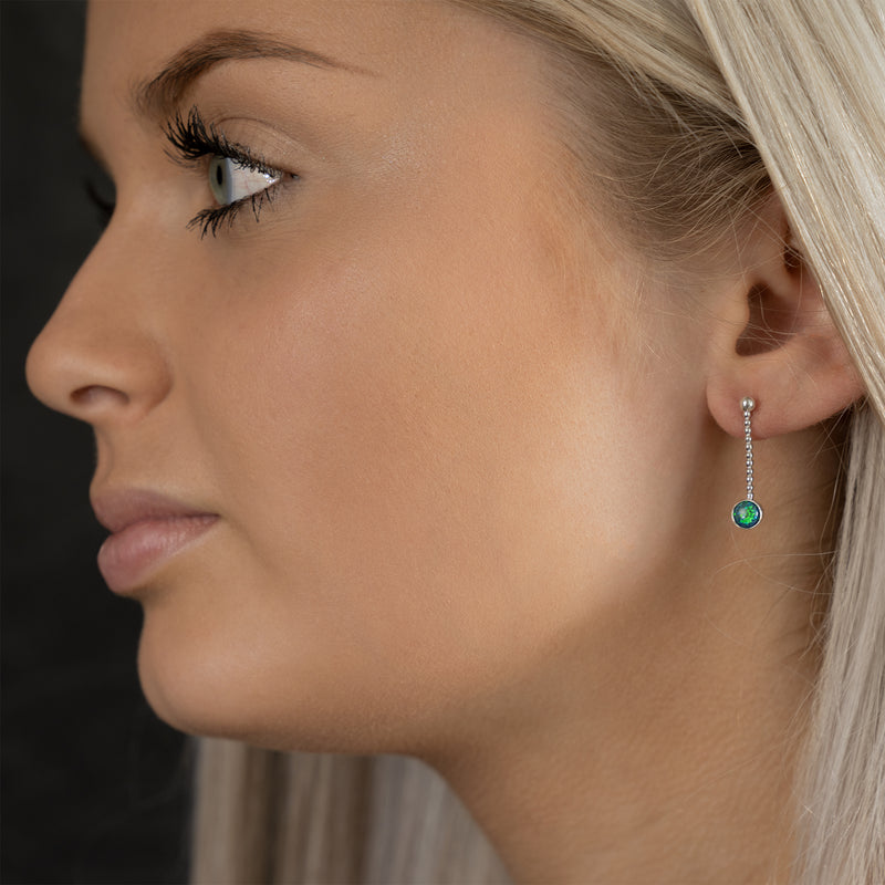 Model wearing Microcosm earrings by Rouaida.